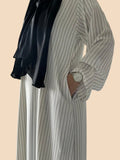 Pinstripe kaftan featuring black stripes and a stylish black scarf, perfect for elegant and comfortable dressing.